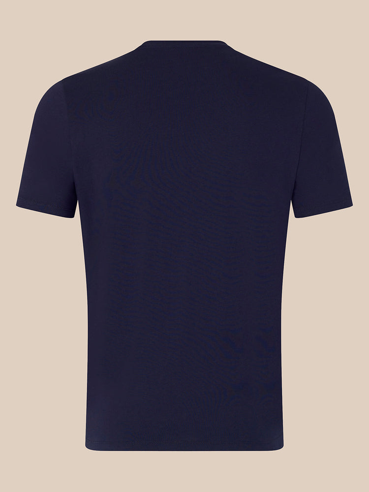 A plain navy blue short-sleeve crewneck t-shirt shown from the back, displayed on a solid light beige background.
